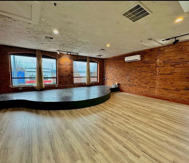 Vibe Fitness Studio: brick walls, arched windows and warm wood floors